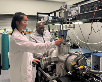 A student and professor using the BrightSpec instrument in a lab